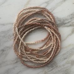 Soft, soothing tones -- eggshell to french vanilla to pale taupe to mocha -- blend into a nearly seamless ombre, sparked with stretches of metallic pearl blush seed beads and trios of pale-blush faceted fire-polished Czech glass beads. Wear as a wrap bracelet of many different ways as a necklace. --- LENGTH: Approximately 78 inches, to wrap around the wrist 11 or 12 times. Can be wrapped around the neck 5 times to make a short choker, or worn in long loops, knotted, layered. See photos for ideas Adjustable Single Strand Cream Jewelry, Adjustable Cream Single Strand Necklace, Handmade Cream Pearl Beaded Bracelets, Adjustable Pearl Bracelets, Adjustable Cream Pearl Bracelets, Elegant Adjustable Beige Beaded Necklace, Elegant Beige Adjustable Beaded Necklace, Adjustable Cream Pearl Beaded Bracelets, Adjustable Cream Pearl Beaded Bracelet