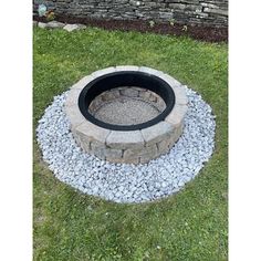 an outdoor fire pit with gravel around it