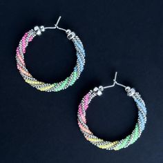 A beautiful mini rainbow for your ears! Blue, green, yellow, orange, fuchsia and silver glass beads on sterling silver earring wire with sterling silver accent beads.  Sterling Silver (100% Post Consumer Recycled ear wire)  Glass Beads UV (Black light) reactive Length about 1.2 inches Made in Tucson, AZ Multicolor Wire Wrapped Hoop Earrings For Gifts, Multicolor Wire Wrapped Round Earrings, Multicolor Wire Wrapped Hoop Earrings Gift, Rainbow Hypoallergenic Hoop Earrings, Hypoallergenic Rainbow Hoop Earrings, Multicolor Hoop Earrings With Ear Wire, Rainbow Nickel-free Dangle Hoop Earrings, Nickel-free Rainbow Dangle Hoop Earrings, Multicolor Wire Wrapped Earrings With Round Beads