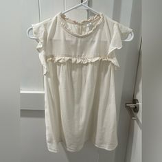 Old Navy Blouse. Size Xs. Light Cream Color. Has Cute Ruffled Details And Flowy Very Short Sleeves. Somewhat Sheer. Never Worn And In Flawless Condition! Approximate Measurements Lying Flat: Pit To Pit: 17” Length Shoulder To Bottom Hem: 22” Make An Offer! Chic Flowy Top For Daywear, Casual Flutter Sleeve Tops With Lace Trim, White Ruffle Sleeve Top For Daywear, Feminine Daywear Tops With Flutter Sleeves, White Flowy Blouse With Flutter Sleeves, Chic Beige Tops For Daytime, Feminine Flutter Sleeve Tops For Daywear, Feminine Flowy Tops For Daywear, Flowy Feminine Tops For Daywear