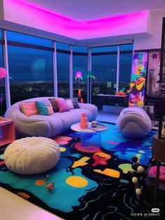 a living room filled with lots of furniture and large windows overlooking the city at night