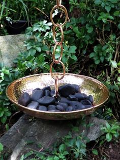 a metal bowl filled with rocks and chains