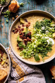 two bowls filled with soup and topped with toppings