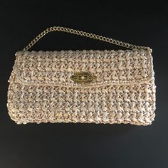 Raffia vintage handbag~  A very elegant handbag to style with your next evening wear. This stylish bag has a gold turn lock to keep things safe but offer that very vintage classy feel. A short gold chain accents this purse for close carrying. Inside is plastic to keep things clean, as well as a small, zippered pocket for credit cards or what not.  The Raffia is in excellent condition on this piece. We are a nonsmoking pet free environment. Elegant Gold Straw Bag With Gold-tone Hardware, Gold Bag With Gold Clasp For Everyday Use, Gold Bags With Gold Clasp For Everyday Use, Gold Everyday Bag With Gold Clasp, Everyday Gold Bag With Gold Clasp, Classic Gold Top Handle Evening Bag, Classic Gold Evening Bag With Top Handle, Summer Evening Clutch With Detachable Handle, Elegant Rectangular Shoulder Bag With Fold Over Clasp