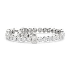 A sweeping sense of sophistication is deeply embedded within this tennis bracelet's timeless design. Bezel-set radiant and round diamonds line up to form a pattern, leading the eye from one flash of sparkle to another. Fastening the bracelet onto your wrist is a secure tongue-and-clip clasp. Elegant Tennis Bracelet In Diamond White With Bezel Setting, Elegant Diamond White Tennis Bracelet With Bezel Setting, Luxury Diamond White Tennis Bracelet With Bezel Setting, Luxury Tennis Bracelet In Diamond White With Bezel Setting, Elegant Diamond Tennis Bracelet With Bezel Setting, Luxury Cubic Zirconia Tennis Bracelet With Bezel Setting, Elegant White Gold Tennis Bracelet With Bezel Setting, Luxury Cubic Zirconia Bezel Setting Tennis Bracelet, Formal Diamond White Tennis Bracelet With Bezel Setting