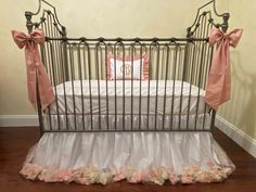 a baby crib with pink and white bedding