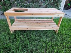 a wooden bench sitting on top of a lush green field