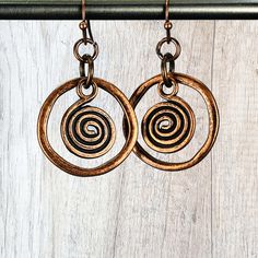 These organic shaped antique copper hoop earrings featuring a spiral charm are beautifully detailed and go with everything! Medium sized, the circle drop is one inch in diameter. Easy go-to earrings for any time.  Custom ear wire style choice at checkout. Hypoallergenic ear wires (nickel and lead free).  Free gift packaging included. Earrings are carded and in an organza bag. Link to my shop: https://www.etsy.com/shop/JezaJewelry Copper Hoop Spiral Earrings - Boho Dangle Earrings - Trending Gift Nickel Free Circle Bronze Jewelry, Nickel-free Bronze Circular Jewelry, Antique Gold Copper Earrings Nickel Free, Antique Finish Copper Dangle Earrings, Antique Gold Nickel-free Copper Earrings, Antique Finish Copper Drop Earrings, Nickel-free Antique Gold Copper Earrings, Electroformed Metal Hoop Earrings, Antique Finish Copper Earrings As Gift