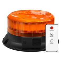 an orange light sitting next to a remote control