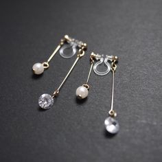 Double sided cz crystal clip on earrings, cubic zirconia, silver clip on earrings dangle, invisible clip on earrings, pearl clip on earrings 💖More pierced look and comfortable invisible clip on earrings are available at MiyabiGrace home page. Please click the link below https://www.etsy.com/shop/MiyabiGrace Details ◆Length:1.57 inches (4 cm) ◆Weight:1 g (0.04 oz) ◆Color: Gold ✨These are gorgeous double sided invisible clip on earrings. Pearls are attached to the front and cubic zirconia crystal Clip On Earrings Dangle, Dangly Clip On Earrings, Diy Clip On Earrings, Prom Inspo, Gold Clips, Handmade Wire Jewelry, Earrings Pearl, Handmade Wire, Delicate Earrings