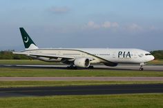 a large passenger jet sitting on top of an airport tarmac with grass around it