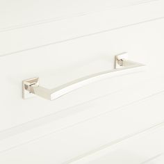 a white cabinet door with two handles on it