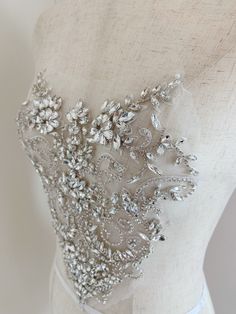 Rhinestone bead applique, crystal bodice patch, heavy bead handmade SIZE: 26cm at the widest point 25cm in height in central This stunning rhinestone applique is hand crafted, design with elegant florals. There is no iron on glue on the back, sew it to your dress . Suitable for bridal dress, evening dress and haute couture for special events, highly recommended for bridals and designers. SUPER LUXURY, HIGHLY RECOMMENDED! SIMILAR ITEMS: https://www.etsy.com/listing/1143786315/pale-blue-french-bea Wedding Corset With Sequins And Fitted Bodice, Glamorous Embellished Wedding Dress With Sweetheart Neckline, Glamorous Embellished Wedding Corset, Elegant Embellished Wedding Corset, Fitted Sequin Wedding Corset, Glamorous Sequined Corset For Wedding, Wedding Corset With Embellished Fitted Bodice, Wedding Fitted Sequin Corset, Wedding Corset With Embellished Sweetheart Neckline