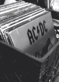 a bunch of records sitting on top of each other in a bin with butterflies flying over them