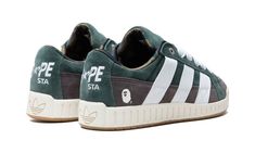 The BAPE x adidas N “Shadow Green” is a collaboration by the iconic Japanese streetwear brand and adidas on the casual sneaker.  The BAPE x adidas N Pack celebrates the brands’ storied partnership.  Available in “Shadow Green” and “Sand,” the adidas N by BAPE has an early 2000s-era skate shoe design.  Specifically, the shoe’s upper is complete with a Shadow Green and Brown suede construction.  Oversized white nylon Three Stripes branding appears on both sides, while BAPE’s signature camo motif a Bape Shoes, Stripes Branding, 2000s Era, Shoe Design, Skate Shoe, Japanese Streetwear, Stadium Goods, Early 2000s, Skate Shoes