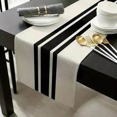 a black and white table with goldware on it