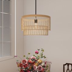 a vase with flowers sitting on top of a table next to a chair and window