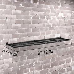 a black and white photo of a shelf on a brick wall with measurements for each shelf