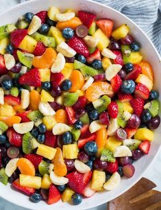 a white bowl filled with mixed fruit salad