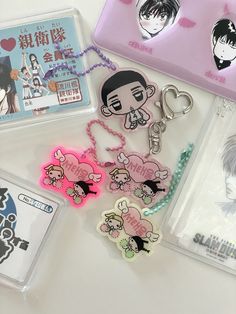 various items are displayed on a table with tags and stickers around them, including keychains