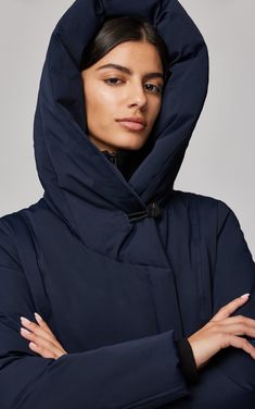 The CAMELIA-C by SOIA & KYO is an above-the-knee-length coat engineered to keep you comfortable up to -30 °C (-22 °F). Made using RDS certified classic down, this slim-fit winter essential has you covered with an impressive, oversized hood and channel-quilted bib + rib-knit zippered collar. Finished with a sleek asymmetrical zipper. Large hood with hidden button closure at hood opening Asymmetric front closure with 1-way metal zipper Front placket over zipper with hidden snaps Nylon channel quil Cold Weather Windproof Outerwear In Recycled Polyester, Cold Weather Outerwear With Detachable Hood In Recycled Polyester, Windproof Recycled Polyester Outerwear For Cold Weather, Recycled Polyester Outerwear With Detachable Hood For Cold Weather, Recycled Polyester Outerwear With Detachable Hood For Outdoor, Hooded Recycled Polyester Outerwear, Navy Outerwear With Detachable Hood For Cold Weather, Functional Navy Outerwear For Cold Weather, Functional Navy Hooded Outerwear