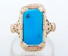 "This antique ring is an eye-popper! We put this fabulous elongated turquoise stone in an equally fabulous antique setting and we really love the outcome. The bright blue turquoise is an impressive 3.86 carats and looks amazing within the intricately detailed two-tone gold setting. This could be your new signature antique ring! Antique Ring - Antique 14k Yellow Gold Elongated Turquoise Filigree Ring 14k Yellow Gold Turquoise = 3.86cts Ring Size 6 (sizable) Ring measures approximately 3/4\" tall. Antique Wedding Bands, Precious Rings, Antique Wedding, Antique Ring, Ring Antique, Filigree Ring, Blue Turquoise, Antique Rings, Gold Style