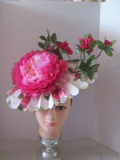 "*  This folded pink floral hat base has a 14\" diameter and has been tilted to the right side of the head.  It is secure, balanced and comfortable to wear for extended periods of time. *  The jumbo pink peonies with the wired azaleas create drama and allure. *  Designed on a satin covered acrylic headband it is comfortable to wear. *  Perfect for the Kentucky Derby or any other horse race, and/or any celebrations that are connected to horse events.  In addition, wear it to a ladies luncheon, fa Luxury Pink Fascinator For Garden Party, Spring Flower Hats For Races, Fitted Flower Hat For Garden Party, Pink Brimmed Fascinator For Spring, Pink Flower Mini Hat For Garden Party, Pink Hats With Handmade Flowers For Spring, Pink Floral Print Hat For Summer, Spring Pink Hats With Handmade Flowers, Spring Races Flower Hat