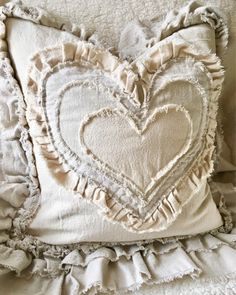 a heart shaped pillow with ruffled edges