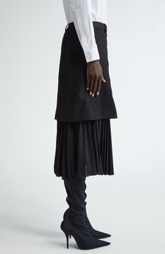 The label known for its bold innnovation plays with the proportions of a crinkled wool skirt boasting a sharply pleated underlayer. 30" length (size 38 FR) 100% wool with 100% polyester contrast Dry clean Made in Italy Designer Clothing Fitted Asymmetrical Skirt For Layering, Pleated Draped Flared Skirt For Work, Elegant Pleated Flared Draped Skirt For Work, Relaxed Tiered Skirt With Folds, Elegant Flowy Skirt For Layering, Asymmetrical Workwear Pleated Skirt, Formal Asymmetrical Skirt With Accordion Pleats, Formal Skirt With Folds, Elegant Long Skirt For Layering