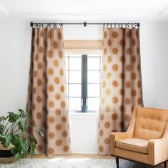 a living room with a chair, window and rug in front of the couches