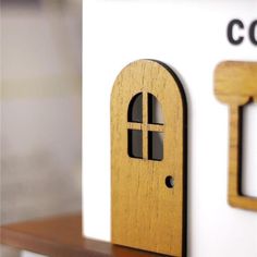 a close up view of a wooden door and keyhole on a dollhouse house