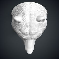 a white sculpture of a bear's head on a black background