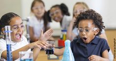 two young children are playing with beakles and flasks in a science class