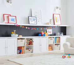 a child's playroom with white furniture and toys