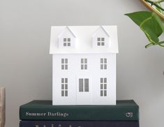 a house model sitting on top of two books