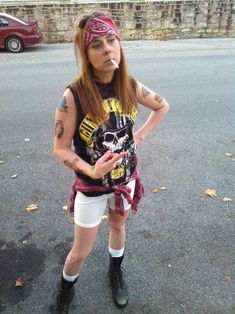 a woman with tattoos standing in the street