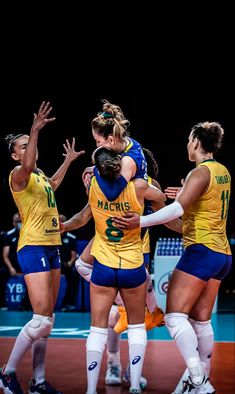 the women's volleyball team huddle together on the court