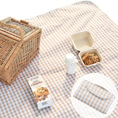 the picnic table is set with cookies and milk