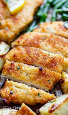 chicken and potatoes in a skillet with parmesan cheese on the side, ready to be eaten