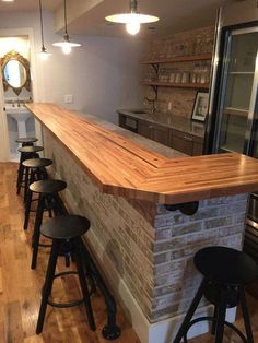 an empty bar with stools next to it