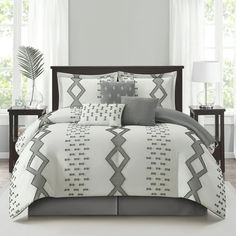 a white and grey bed in a bedroom