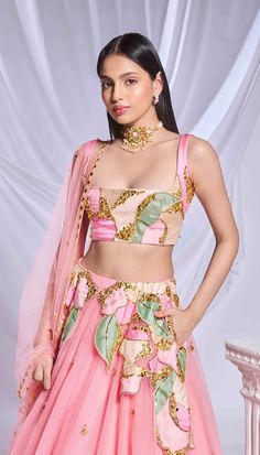 Our pink tulle lehenga is adorned with intricate patchwork embroidery and metallic accents cascading from the waist to the hips. The lehenga is embellished with scatter embroidery, featuring gold elements and delicate pink crystals throughout. Completing the ensemble is a sleeveless pink blouse featuring matching patchwork.From Papa Don’t Preach’s Bring Your Own Fairytale collection. DELIVERY TIMEPlease allow 8-12 weeks for your outfit to arrive. FABRIC DETAILSTulle Professional cleaning only. Pink Hand Embellished Dupatta For Diwali, Hand Embellished Pink Dupatta For Diwali, Pink Hand Embellished Lehenga For Festivals, Pink Resham Embroidered Organza Sharara, Designer Pink Hand Embellished Sharara, Pink Bollywood Style Hand Embellished Dupatta, Bollywood Style Pink Hand Embellished Dupatta, Pink Bollywood Hand Embellished Dupatta, Glamorous Pink Designer Wear Choli