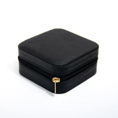 DESCRIPTION & DETAILS Take Sincere Sally's Jewelry Case wherever you go while keeping your special jewelry pieces in place. With six ring holders, three hanging spaces, pouch and adjustable dividers, this case is compact enough to fit in your purse or luggage. Materials: Black Vegan Leather & 14k Gold Plated Metal Zipper Width: 10cm Length: 10cm Height: 4.5cm SUSTAINABILITY In-house plating - All pieces are handcrafted by our in-house jewelers ensuring a high standard of working conditio Rectangular Black Cosmetic Bag Gift, Elegant Round Case Bag As Gift, Elegant Rectangular Travel Organizer, Elegant Travel Organizer, Rectangular Shape, Black Rectangular Cosmetic Bag Gift, Compact Portable Jewelry Storage For Everyday, Elegant Rectangular Cosmetic Bag For Storage, Elegant Compact Case With Included Case, Elegant Rectangular Cosmetic Storage Bag