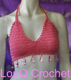 This hand crocheted top is made from 100% cotton with a shimmery glitter look, bordered with small pink beads and large crystal like drop beads around the bottom. The top ties at neck and back bikini style for adjustable sizing depending on how you like to wear it. Completely waterproof to swim in, casual or chic dress up. Summer Party Pink Crochet Top, Pink Triangle Crochet Top For The Beach, Pink Triangle Crochet Top For Beach, Pink Halter Neck Crochet Top For Beach, Pink Triangle Halter Top For Festivals, Pink Crochet Beachwear Top For Festival, Pink Beachwear Crochet Top For Festival, Festival Pink Halter Neck Crochet Top, Pink Crochet Crop Top For Festival