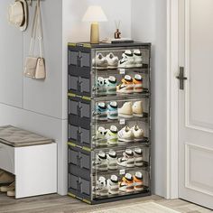 a shoe rack with many pairs of shoes on it next to a white door in a room