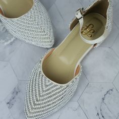 Elevate your style effortlessly with these stunning pearl-embellished flats, designed for the modern woman who values both elegance and comfort. Crafted with meticulous attention to detail, these flats feature a luxurious array of pearls and metallic beads, creating a delicate and sophisticated texture that catches the light with every step. The pointed toe and ankle strap add a touch of femininity and provide a secure, comfortable fit, making these flats perfect for all-day wear. Key Features: Elegant Pearl Embellished Flats For Formal Occasions, Elegant Pearl-embellished Formal Flats, Elegant Pearl Embellished Formal Flats, Elegant Embellished Ballet Flats For Formal Occasions, Elegant Embellished Flat Ballet Flats, Elegant Embellished Ballet Flats, White Pointed Toe Flats For Evening, White Low Heel Ballet Flats For Party, Elegant Pointed Toe Flats With Ankle Strap For Wedding