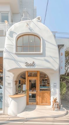 a white building with wooden doors on the outside and windows above it that say love