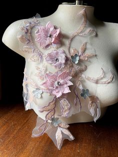 a white mannequin with pink flowers on it