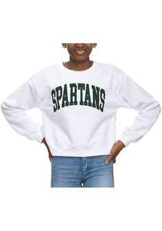 Make your way to the big game in this Michigan State SpartansWomens White Cropped Sport Crew Sweatshirt! This Spartans Long Sleeve Sweatshirt features a applique team name on center chest. Stay warm and comfortable with this Womens MSU Spartans Crew Sweatshirt. Cropped, Crew neck, Long sleeve, Dropped shoulder, 65% COTTON / 35% POLYESTER, 4 Sporty Tops With University Logo For Sports Events, Collegiate Tops For Sports Events, Sporty University Logo Tops For Sports, Sporty Tops With University Logo For Sports, Sporty University Logo Sports Tops, College Style Sports Tops With Team Name, White College Style Sports Top, Fall Sports Team Logo Tops, Fall Sports Event Tops With Team Logo