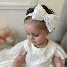 Introduce a touch of elegance and grace to your baby girl's special day with our exquisite Christening Headband. Perfectly designed to complement her Christening outfit, this headband combines delicate craftsmanship with timeless style. ☑ Why Choose This Christening Headband? *This headband is not only a beautiful accessory but also a keepsake that will capture the memory of your baby's special occasion. Crafted with care, it provides a blend of comfort and charm, making it ideal for the most me White Bow Headband For Wedding, White Elegant Baptism Dress For First Birthday, Elegant White Baptism Dress For First Birthday, White Wedding Headband With Bow, White Matching Headband For Baptism, Adjustable Bow Headband For Weddings, Adjustable Wedding Headband With Bow, White Hair Accessories With Matching Headband For Baptism, White Baptism Dress With Satin Bow